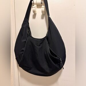 Lightly used shoulder nylon fabric bag from lululemon with multiple pockets